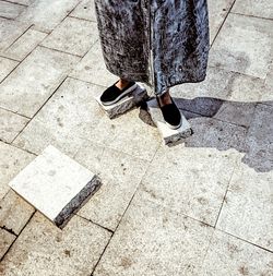 Low section of woman walking on floor