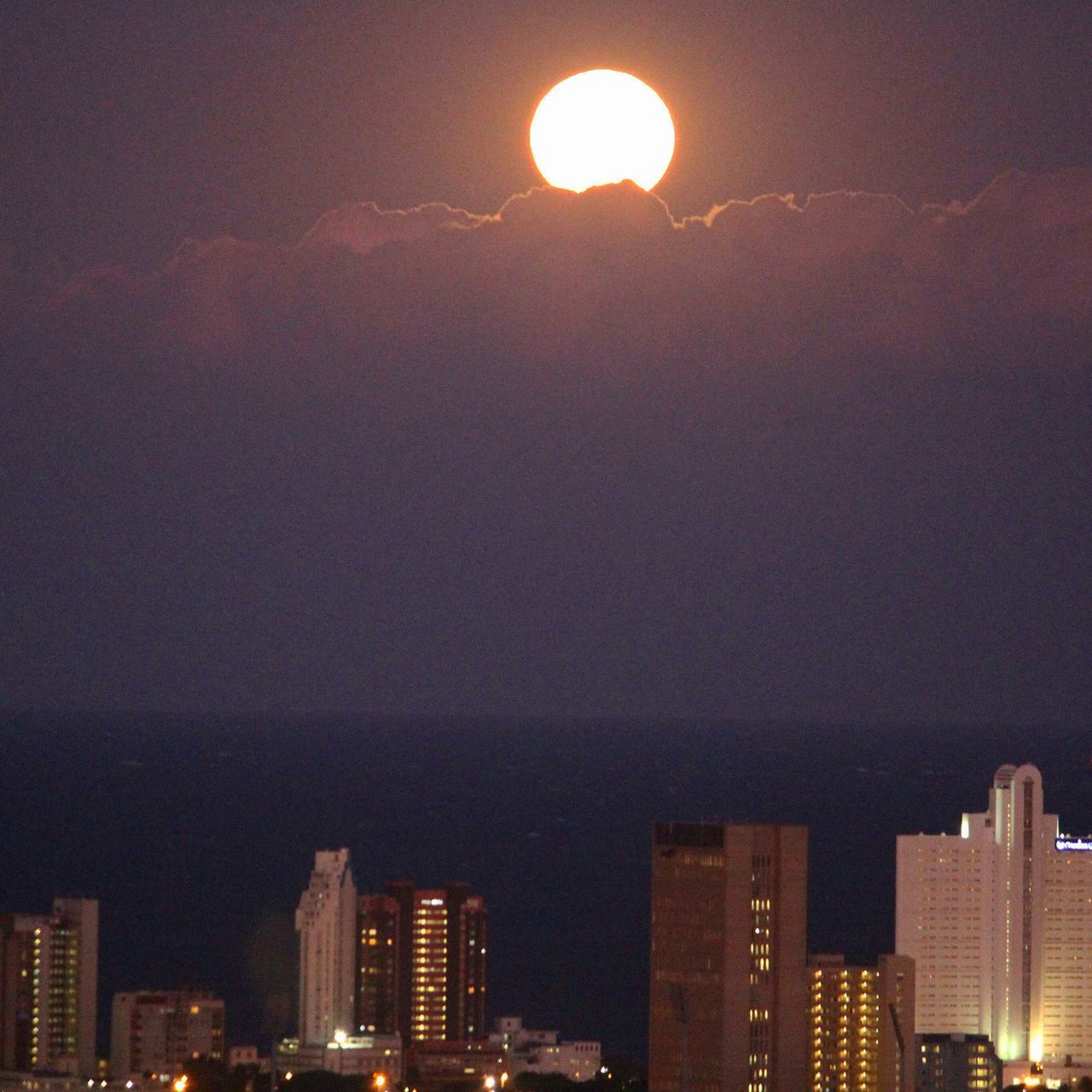 building exterior, architecture, city, built structure, cityscape, illuminated, sky, skyscraper, night, sunset, residential building, modern, residential structure, outdoors, residential district, moon, no people, urban skyline, building, office building