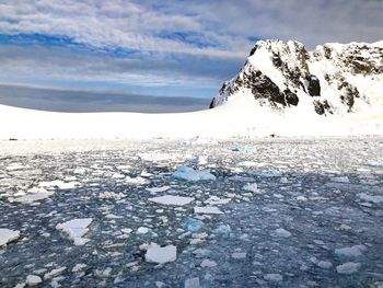 Scenic view of frozen lake against sky during winter