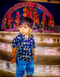 Full length of cute girl looking away