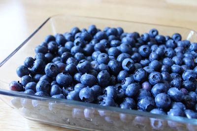 Close-up of blueberries in container on table