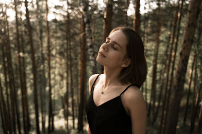 Portrait of young woman in forest