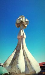 Low angle view of statue against clear blue sky