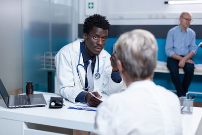 Doctor talking with patient in clinic