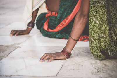 Close-up of human hand resting on floor