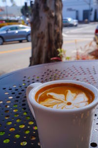 Close-up of cappuccino served on table