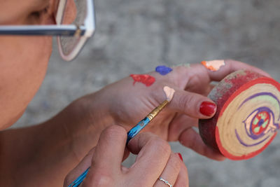 Cropped hand of woman painting