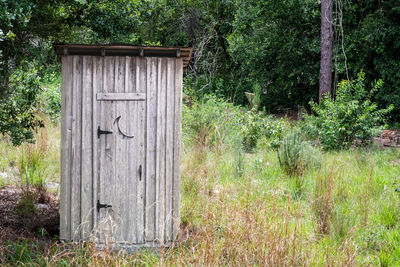 Closed wooden door on field