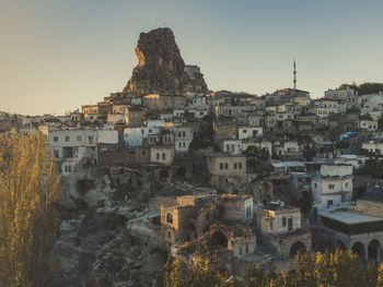 Buildings in city against clear sky