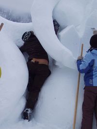 Person covering face covered with snow