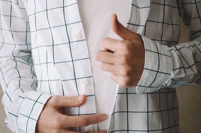 Midsection of man holding umbrella
