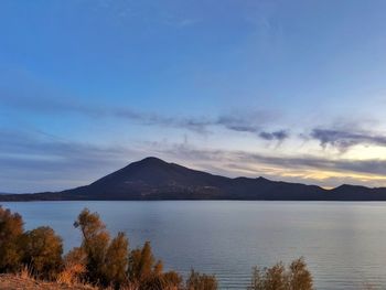 Scenic view of lake against sky during sunset