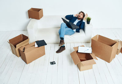 High angle view of senior woman sitting in box