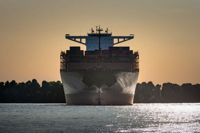 Turning manoeuvre at sunset of a container ship