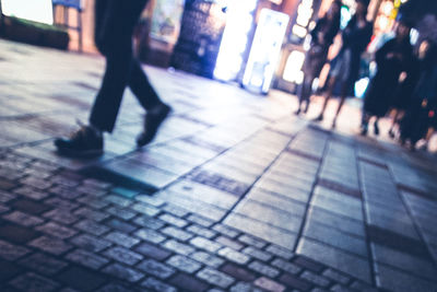 Man standing on footpath at night