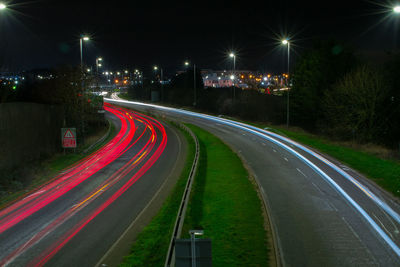 High angle view of light trails on road at night