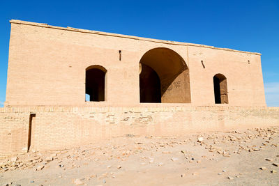 Low angle view of historical building against blue sky