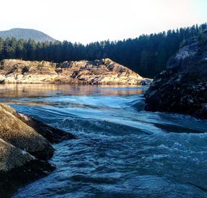 Scenic view of river with mountains in background