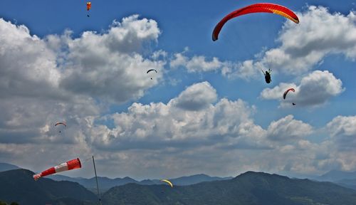 Low angle view of paragliding against sky