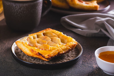 Upside down puff pastry apple tart on a breakfast plate