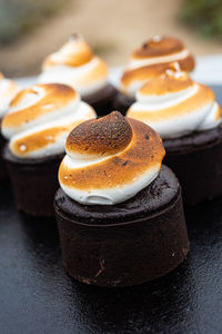 Toasted marshmallow meringue swirls on top of  s'mores baked chocolate brownie cakes dessert snacks