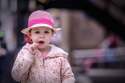Portrait of cute girl having lollipop at outdoors