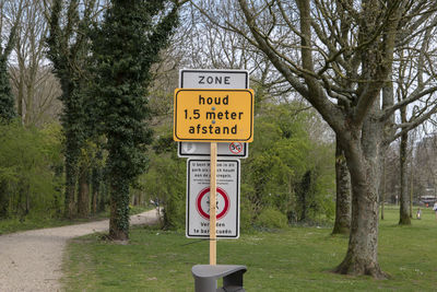 Road sign by trees