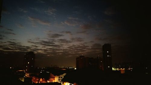 High angle view of illuminated buildings against sky at night