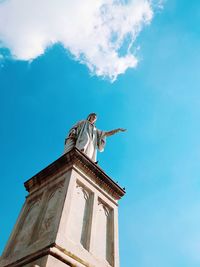 Low angle view of statue against blue sky