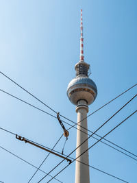 Low angle view of communications tower against sky