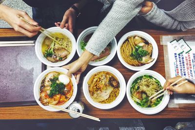 Cropped image of people having food in restaurant