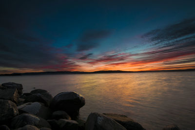 Scenic view of sea against sky at night