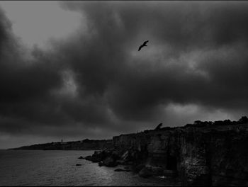 Scenic view of sea against cloudy sky