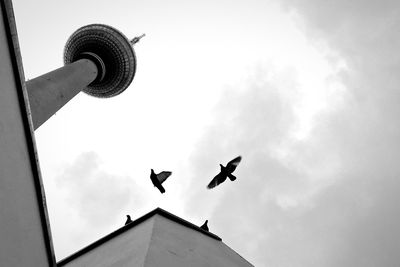 Low angle view of building against cloudy sky