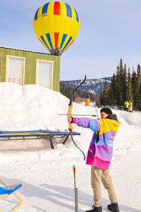 Rear view of man standing on snow