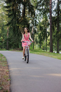 Side view of woman riding motorcycle on road