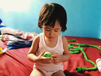 Girl looking away while sitting on mobile phone