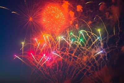 Low angle view of firework display at night
