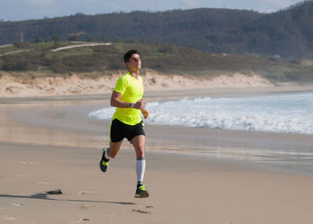 Full length of man running at beach