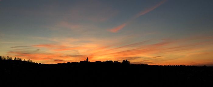 Silhouette trees against sky during sunset
