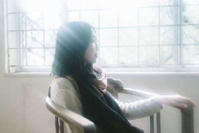 Woman looking through window