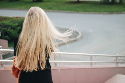 Rear view of woman standing against sea