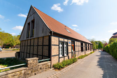 Building by road against sky