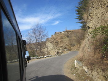 Close-up of car on road against sky