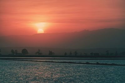 Scenic view of sea against romantic sky at sunset