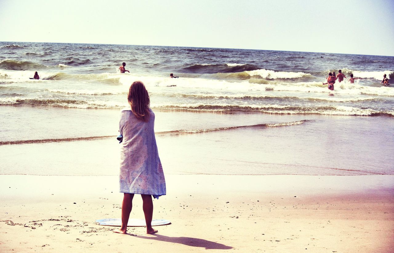 beach, sea, horizon over water, sand, shore, water, lifestyles, leisure activity, person, vacations, rear view, standing, full length, tourist, walking, wave, clear sky, scenics, men