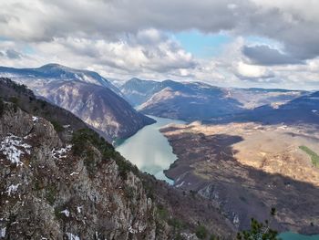 Scenic view of mountains against cloudy sky