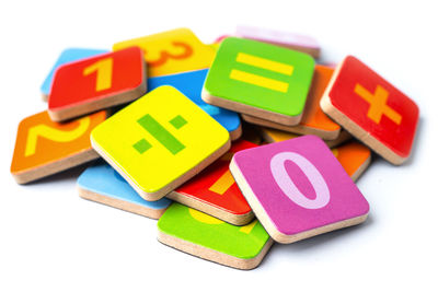 Close-up of toys on table against white background