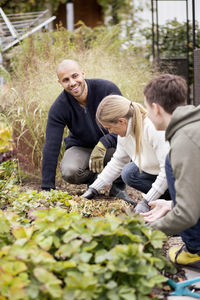 Family of three gardening at yard