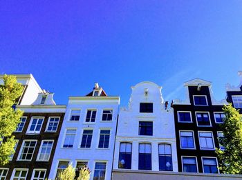 Low angle view of buildings against blue sky